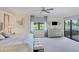 Primary bedroom with lake view, walk-in closet and large windows at 10780 Tarflower Dr # 102, Venice, FL 34293