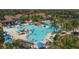 Large community pool with various lounging areas at 10780 Tarflower Dr # 102, Venice, FL 34293