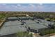 Aerial view of multiple tennis courts with fencing at 10780 Tarflower Dr # 102, Venice, FL 34293