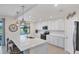 Modern kitchen with white cabinets, quartz countertops, and stainless steel appliances at 10780 Tarflower Dr # 102, Venice, FL 34293
