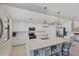 Modern kitchen with white cabinets, quartz countertops, and stainless steel appliances at 10780 Tarflower Dr # 102, Venice, FL 34293