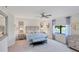Spacious Primary bedroom with large windows, neutral decor, and ceiling fan at 10780 Tarflower Dr # 102, Venice, FL 34293