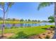 Serene waterfront view with lush landscaping and homes at 10780 Tarflower Dr # 102, Venice, FL 34293