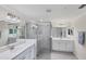 Elegant bathroom featuring a large walk-in shower and double vanities at 10780 Tarflower Dr # 102, Venice, FL 34293