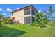 Tan two story house with screened in patio and lake access at 10780 Tarflower Dr # 102, Venice, FL 34293