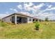 Home exterior and backyard with lake view at 24273 Spartina Dr, Venice, FL 34293