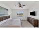 Spacious Primary bedroom with lake view, ceiling fan, and modern dresser at 24273 Spartina Dr, Venice, FL 34293