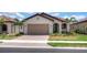 Single-story home with tan garage door and red tile roof at 24273 Spartina Dr, Venice, FL 34293