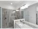 Modern bathroom with granite countertop, single sink, and large shower at 24273 Spartina Dr, Venice, FL 34293