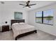 Bright bedroom with lake view, ceiling fan, and carpeted floors at 24273 Spartina Dr, Venice, FL 34293