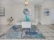 Modern dining area featuring a glass-top table and white chairs at 1403 Gondola Park Dr # 1403Bd, Venice, FL 34292