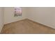 Well-lit bedroom with neutral carpeting and large window at 1403 Gondola Park Dr # 1403Bd, Venice, FL 34292