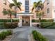 Building entrance with lush landscaping at 1403 Gondola Park Dr # 1403Bd, Venice, FL 34292
