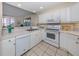 White kitchen features ample counter space and modern appliances at 1403 Gondola Park Dr # 1403Bd, Venice, FL 34292