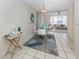 Bright dining area with glass table and white chairs, situated near the living room at 1403 Gondola Park Dr # 1403Bd, Venice, FL 34292