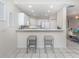 Bright kitchen features white cabinetry, stainless steel appliances, and breakfast bar at 1403 Gondola Park Dr # 1403Bd, Venice, FL 34292