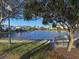 Serene lakefront community with lush landscaping and bench at 1403 Gondola Park Dr # 1403Bd, Venice, FL 34292