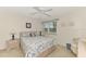 Bedroom with a queen bed, nightstands and ceiling fan at 725 Capri Isles Blvd # 217C, Venice, FL 34292