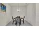 Dining room with four chairs and a chandelier at 11638 Alessandro Ln, Venice, FL 34293