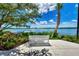 Scenic waterfront view with a peaceful lakeside bench at 11638 Alessandro Ln, Venice, FL 34293