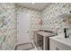 Laundry room with washer, dryer, and floral wallpaper at 12472 Davie Ct, Venice, FL 34293