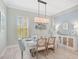 Elegant dining room featuring a light and airy design with a beautiful chandelier at 12472 Davie Ct, Venice, FL 34293