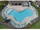 Aerial shot of the community pool, featuring many lounge chairs, tables and umbrellas at 12586 Oak Hill Way, Parrish, FL 34219
