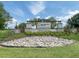 Stone sign for Crosswind Point community with colorful stone landscaping and manicured lawn at 12586 Oak Hill Way, Parrish, FL 34219