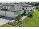 Charming home featuring a three-car garage, manicured landscaping, and a welcoming entrance at 12586 Oak Hill Way, Parrish, FL 34219