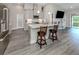 Modern kitchen with stainless steel appliances, quartz countertops, and a stylish island with seating at 12586 Oak Hill Way, Parrish, FL 34219
