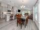 Open-concept living space with modern kitchen, dining area, and a view of the backyard at 12586 Oak Hill Way, Parrish, FL 34219