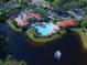 Aerial view of community pool area with a large pool, lounging area and clubhouse at 381 Marsh Creek Rd, Venice, FL 34292