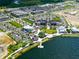 Aerial view of the community showcasing the lake, shopping center and residential area at 381 Marsh Creek Rd, Venice, FL 34292