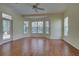 Spacious bedroom featuring hardwood floors, a ceiling fan, and access to the lanai at 381 Marsh Creek Rd, Venice, FL 34292