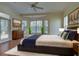 Bright main bedroom featuring a bay window, ceiling fan, and en-suite bathroom access at 381 Marsh Creek Rd, Venice, FL 34292