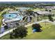 Aerial view of community amenities including pool, clubhouse, and sports fields at 5650 Mashie Cir, North Port, FL 34287