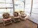 Bright screened porch with wicker chairs and floral cushions at 5650 Mashie Cir, North Port, FL 34287