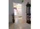Clean entryway with tile floors and a display cabinet at 5650 Mashie Cir, North Port, FL 34287