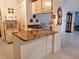 Kitchen island with granite countertop and white cabinets at 5650 Mashie Cir, North Port, FL 34287