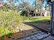 Landscaped backyard with a view of neighboring homes at 5650 Mashie Cir, North Port, FL 34287