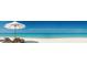 Relaxing beach scene with lounge chairs and umbrella at 5650 Mashie Cir, North Port, FL 34287