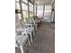 Relaxing screened porch with multiple chairs for seating at 5650 Mashie Cir, North Port, FL 34287