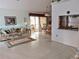Open living area with tile floors, sofa, and dining area at 5650 Mashie Cir, North Port, FL 34287