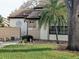 Tan exterior condo with mature landscaping and a walkway at 5650 Mashie Cir, North Port, FL 34287