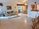 Open living area with tile floors, sofa, and dining area at 5650 Mashie Cir, North Port, FL 34287