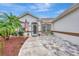 Welcoming front entry with flag and tile walkway at 5856 Wilson Rd, Venice, FL 34293