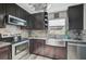 Modern kitchen features stainless steel appliances, granite countertops, and dark wood cabinets at 6738 Brentford Rd, Sarasota, FL 34241