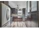 Modern kitchen featuring stainless steel appliances, dark cabinetry, and hardwood floors at 6738 Brentford Rd, Sarasota, FL 34241