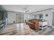 Bright living room featuring wood floors, modern decor, and French doors to the outside at 6738 Brentford Rd, Sarasota, FL 34241