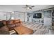 Spacious living room with ceiling fan, built-in shelving, and modern flooring at 6738 Brentford Rd, Sarasota, FL 34241